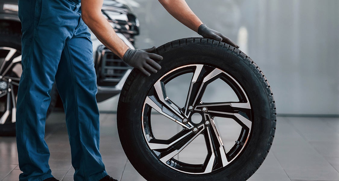 service expert holiding Tire